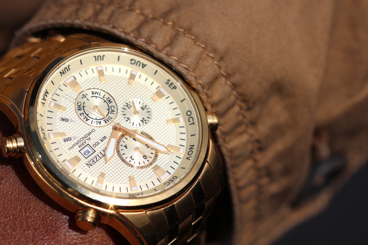 home-hero Close-up of a sophisticated gold wristwatch with functional chronograph and date display.