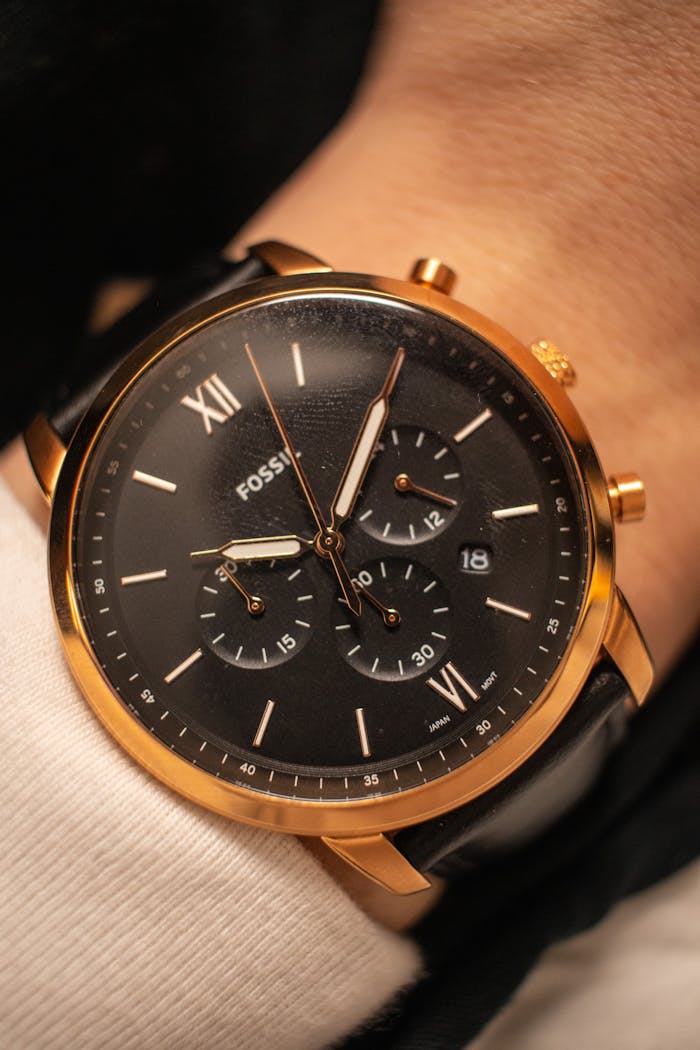 services-05 Close-up of a stylish gold wristwatch, showcasing luxury watch design.